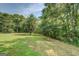 Expansive grassy yard with lush landscaping and mature trees at 369 Parker Rd, Mcdonough, GA 30252