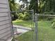 Chain link fence enclosing the backyard, with mature trees and greenery in the background at 8113 Fieldstream Way, Douglasville, GA 30134