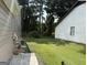 Lawn alongside home with mature trees and an air conditioning unit at 8113 Fieldstream Way, Douglasville, GA 30134