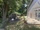 Backyard view showing a shed, patio, partial fence, and mature trees at 8113 Fieldstream Way, Douglasville, GA 30134