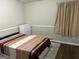 Bedroom featuring a neatly made striped bed, white dresser and natural light at 8113 Fieldstream Way, Douglasville, GA 30134