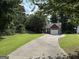 Charming home with a large yard, long driveway, brick accents, and mature trees at 8113 Fieldstream Way, Douglasville, GA 30134