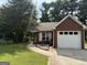 Charming brick home with a well-maintained lawn and an attached one car garage at 8113 Fieldstream Way, Douglasville, GA 30134
