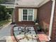 Charming brick home featuring a garden bed with flowers and a window with decorative shutters at 8113 Fieldstream Way, Douglasville, GA 30134