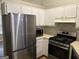 Modern kitchen with stainless steel appliances and ample cabinet space, perfect for cooking at 8113 Fieldstream Way, Douglasville, GA 30134