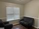 Charming living room featuring cozy seating and bright natural light at 8113 Fieldstream Way, Douglasville, GA 30134
