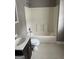 Bathroom features a sink, toilet, and shower with white tile at 3155 E Point St, East Point, GA 30344