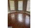 Bright living room featuring hardwood floors and large windows with blinds at 3155 E Point St, East Point, GA 30344