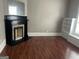 Cozy living room featuring a decorative fireplace, built-in shelves, and hardwood floors at 3155 E Point St, East Point, GA 30344