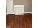 Living room featuring hardwood floors and non-functional fireplace at 3155 E Point St, East Point, GA 30344