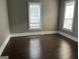 Large, sunny living room with hardwood floors and bright windows at 3155 E Point St, East Point, GA 30344