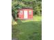 Backyard features a red storage shed, offering practical space for gardening tools or outdoor equipment at 3155 E Point St, East Point, GA 30344