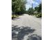 Residential street lined with trees and houses on either side at 3155 E Point St, East Point, GA 30344