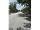 View of long residential street, lined with homes and trees at 3155 E Point St, East Point, GA 30344