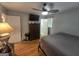 Bedroom with hardwood floors, fan, tv, and furnishings, including a decorative dresser at 439 River Rd, Jonesboro, GA 30236