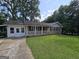 Charming single-story brick home with a covered front porch and a well-maintained lawn at 439 River Rd, Jonesboro, GA 30236