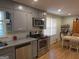 Well-lit kitchen with stainless steel appliances, gray cabinetry, and granite countertops at 439 River Rd, Jonesboro, GA 30236