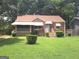 Charming brick home with a well-maintained lawn and covered porch, surrounded by mature trees at 1712 Clifton Se Way, Atlanta, GA 30316