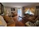 Cozy living room featuring hardwood floors, classic furnishings, and natural light streaming through large windows at 1712 Clifton Se Way, Atlanta, GA 30316