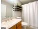 Bathroom featuring a vanity, toilet, and shower with a white curtain at 5553 Strathmoor Manor Cir, Lithonia, GA 30058