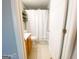 Bathroom features a vanity, toilet, and shower with a white curtain at 5553 Strathmoor Manor Cir, Lithonia, GA 30058