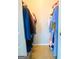 Walk-in closet filled with an assortment of clothes hanging on rods at 5553 Strathmoor Manor Cir, Lithonia, GA 30058