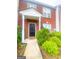 Charming brick townhome with a welcoming front entrance and a well-maintained landscaped yard at 5553 Strathmoor Manor Cir, Lithonia, GA 30058