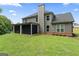 Exterior view of home with a screened in porch and large backyard at 935 S Laney Rd, Locust Grove, GA 30248