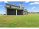 Expansive backyard featuring a screened-in porch, perfect for outdoor entertaining and relaxation at 935 S Laney Rd, Locust Grove, GA 30248