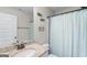Bathroom with granite counters, decorative shower curtain and modern fixtures at 935 S Laney Rd, Locust Grove, GA 30248