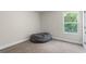 Bedroom with neutral carpet, a beanbag chair, and a window at 935 S Laney Rd, Locust Grove, GA 30248