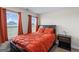 Bedroom with a large bed, matching nightstand, and views through the windows at 935 S Laney Rd, Locust Grove, GA 30248