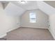 Spacious bonus room with neutral carpet, a window, and two doors at 935 S Laney Rd, Locust Grove, GA 30248