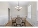 Cozy dining room with a round table, elegant chandelier, and wainscoting details at 935 S Laney Rd, Locust Grove, GA 30248