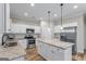 This modern kitchen has granite counters, stainless appliances and an island at 935 S Laney Rd, Locust Grove, GA 30248