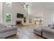 Bright living room featuring a fireplace, high ceilings, and an open-concept layout into kitchen at 935 S Laney Rd, Locust Grove, GA 30248