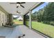 A screened porch featuring a hammock and two ceiling fans at 935 S Laney Rd, Locust Grove, GA 30248