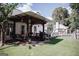 Spacious backyard featuring a covered patio area, lush green lawn, and a play structure in the distance at 401 N Lost Lake Cv, Villa Rica, GA 30180