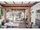 Covered porch with an outdoor seating area, swing and grill, and a backyard playset at 401 N Lost Lake Cv, Villa Rica, GA 30180