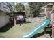 Private backyard oasis featuring a play set, covered patio, and manicured lawn perfect for entertaining at 401 N Lost Lake Cv, Villa Rica, GA 30180