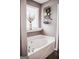 Bathroom showcasing a white tub with a view from the doorway and decor at 401 N Lost Lake Cv, Villa Rica, GA 30180