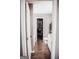 Hallway view of an ensuite bathroom featuring a bathtub, closet and granite countertops at 401 N Lost Lake Cv, Villa Rica, GA 30180