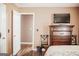 Bedroom featuring a TV mounted on the wall, a dresser, and a view into an adjacent room at 401 N Lost Lake Cv, Villa Rica, GA 30180