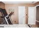 Bedroom featuring a treadmill and multiple doors, offering ample space at 401 N Lost Lake Cv, Villa Rica, GA 30180