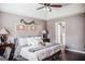 Spacious bedroom with tray ceiling, ceiling fan, and neutral décor for a relaxing retreat at 401 N Lost Lake Cv, Villa Rica, GA 30180