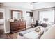 Bedroom showcasing a wooden dresser with a mirror, a workstation, and warm, inviting decor at 401 N Lost Lake Cv, Villa Rica, GA 30180