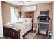 Bedroom with a large bed, dark furniture, a window, and treadmill for exercise at 401 N Lost Lake Cv, Villa Rica, GA 30180