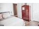 Comfortable bedroom with a decorative armoire, and a well-lit bedside table at 401 N Lost Lake Cv, Villa Rica, GA 30180
