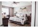 Luxurious bedroom with hardwood floors, neutral tones, and tray decor on the bed at 401 N Lost Lake Cv, Villa Rica, GA 30180