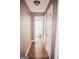 Hallway with hardwood floors leading to the bathroom with modern finishes and fixtures at 401 N Lost Lake Cv, Villa Rica, GA 30180